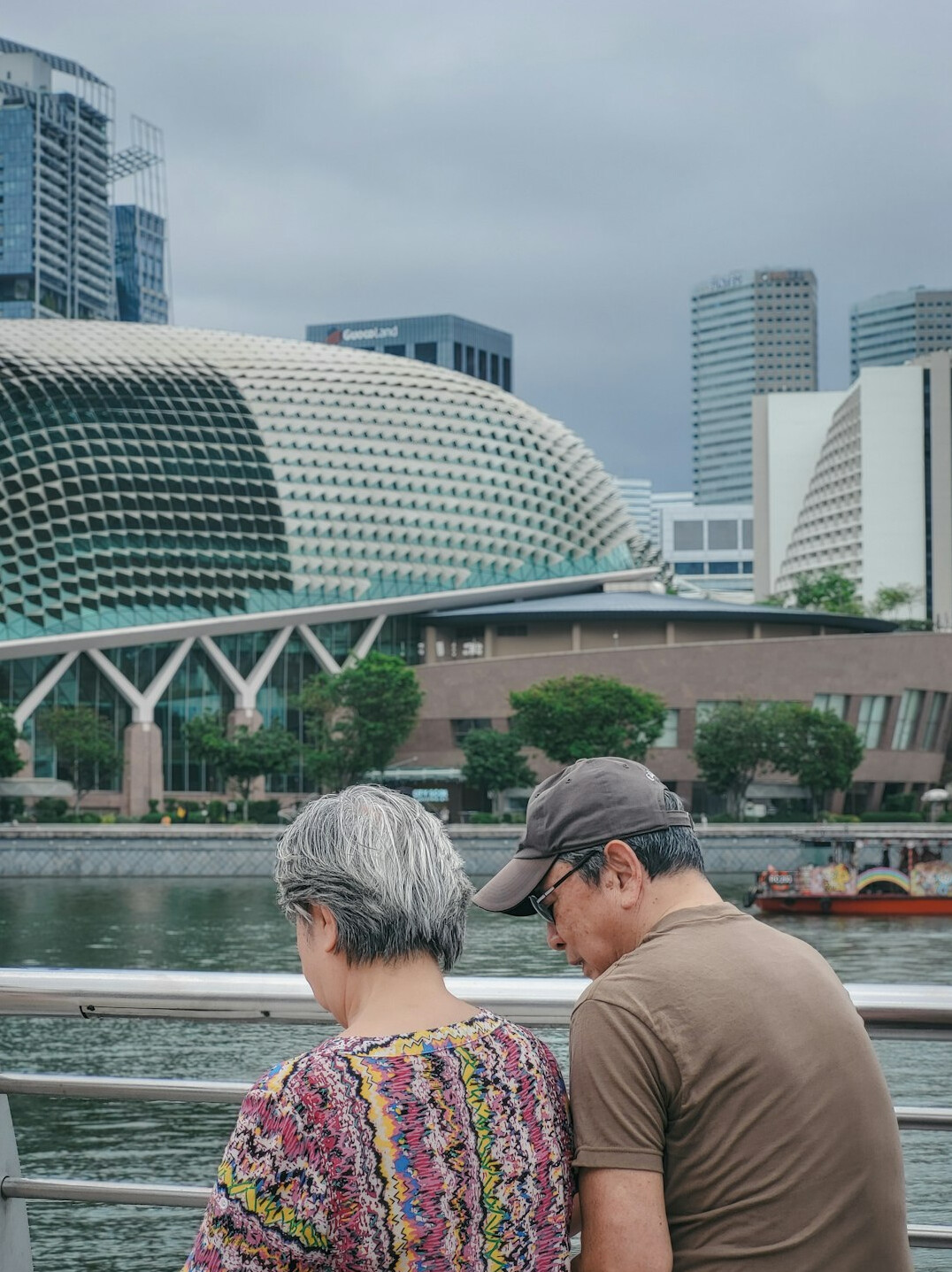 Insurance advisor discussing a health policy with a client in a bright Singapore office